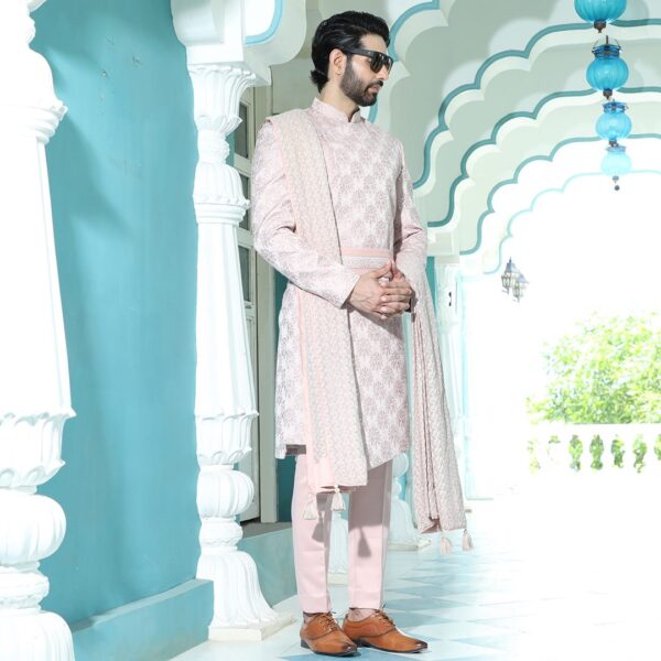 An asymmetrical cherry blossom high low cut sherwani. It is enhanced with thread and mirror work all over.