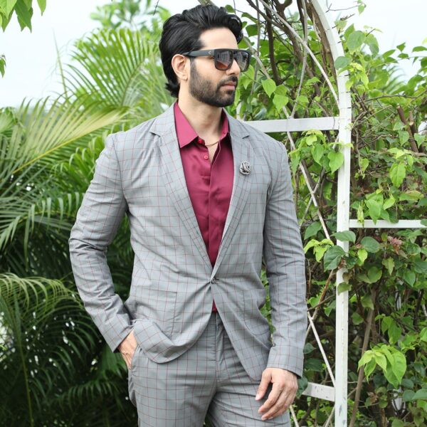 An ash grey checks blazer with single button and dual lapel. It is enhanced with two down patch pockets. - Image 2