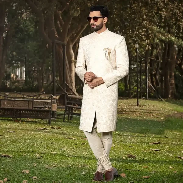 Ivory sherwani with floral motif, concealed buttons, round collar and straight hemline