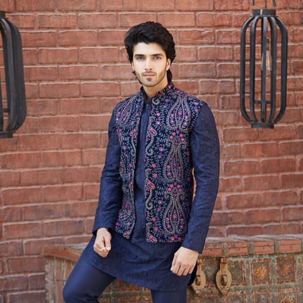 Midnight blue front open jacket  embroidered with plum and french rose flowers all over paired with midnihgt blue kurta.