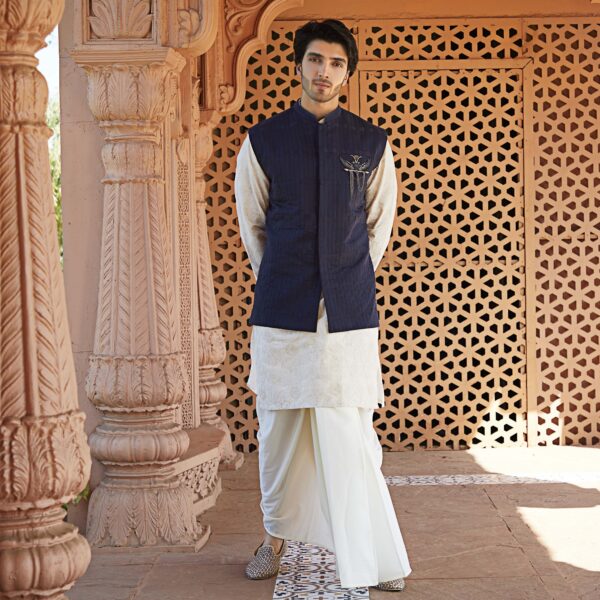 Midnight Blue assymetric Blocked jacket teamed up with time travel space embroidered off white kurta.