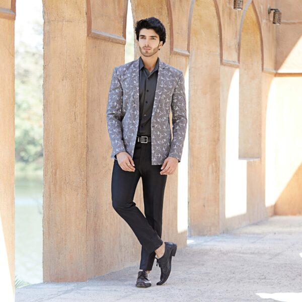 Grey blazer with thread and sequence highlighted birds all over. It is teamed up with grey pathani.