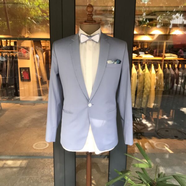 Sky blue single button blazer with horizontal thread work on lapel & accessorised with a bow & pocket square