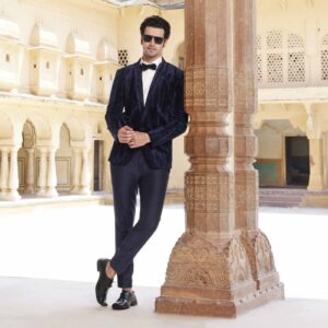 Midnight blue velvet tuxedo with crystal detailing all over paired with an off white shimmer shirt. Matching trousers for bottom. Accessorised with matching bow tie. Styled with matching formal shoes.
