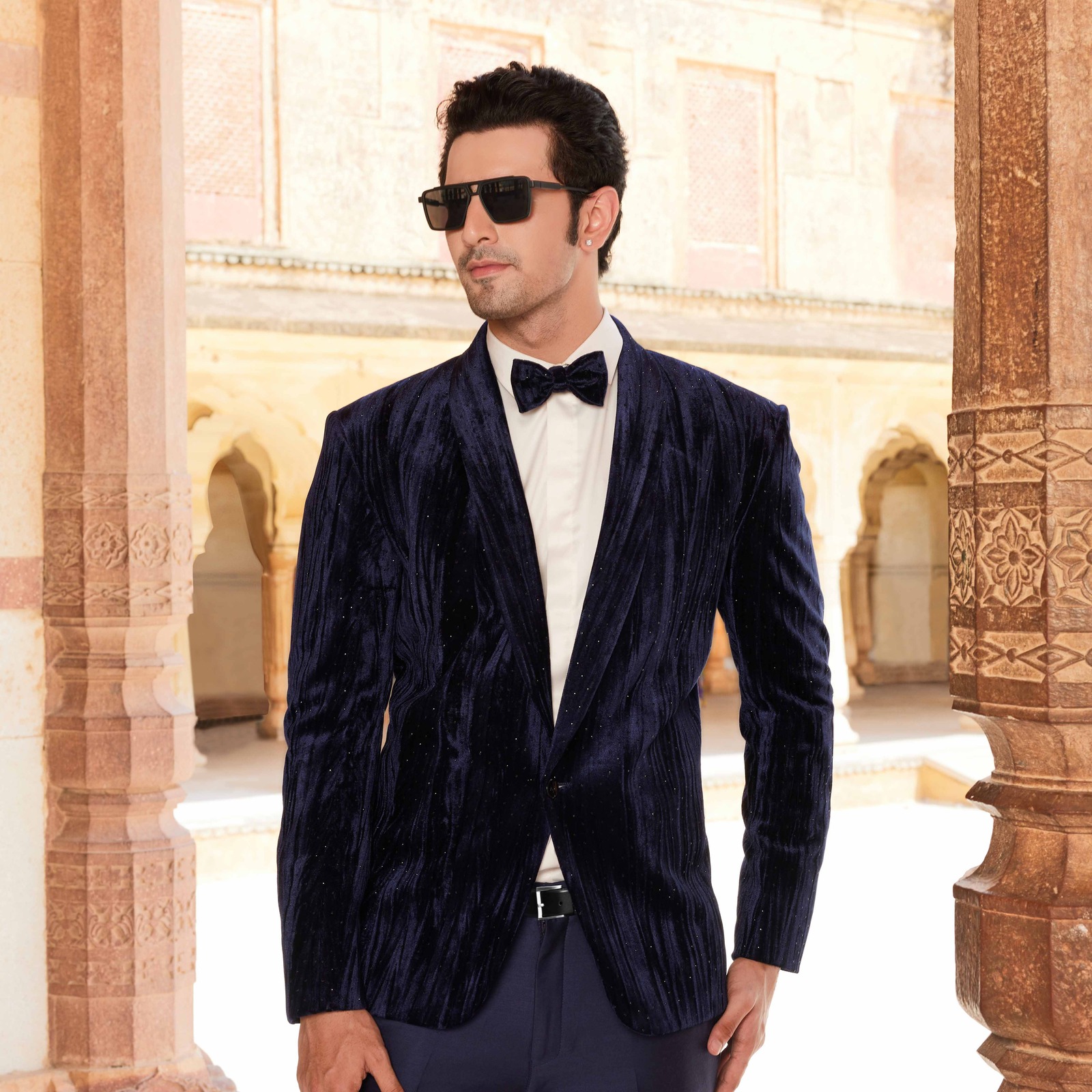 Midnight blue velvet tuxedo with crystal detailing all over paired with an off white shimmer shirt. Matching trousers for bottom. Accessorised with matching bow tie. Styled with matching formal shoes. - Image 2