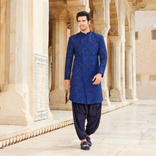 Egyptian blue overlapped bandhgala with intricate buggle beads and thread detailing all over. Midnight blue Afghani for bottoms. Styled with coordinated loafers.