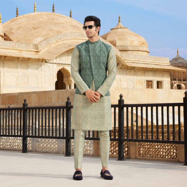 Foliage green full hand embroidered asymmetric jacket paired with knights embroidered pearl grey kurta. Matching trousers for bottom. Styled with loafers.