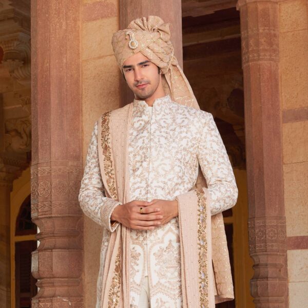 Ivory sherwani with old rose embroidery and sequence detailing all over. Matching trousers for bottom accessorised with coordinated safa and stole with peacock border. Styled with coordinated embroidered loafers. - Image 2