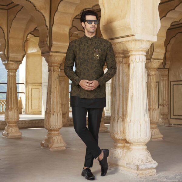 Dark Olive Bandhgala with surface detailing of Shield embroidery all over. Antique gold brooch on one side. The ensemble is paired with cube embroidered black short kurta & matching trousers. Styled with matching formal shoes.