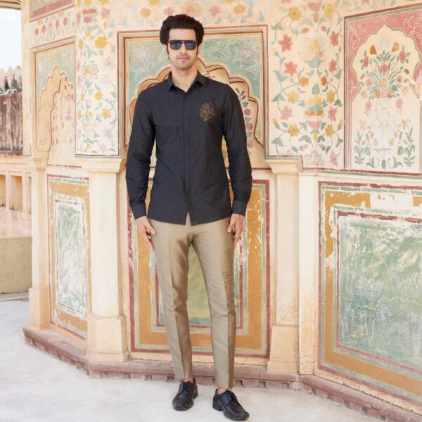 Black shirt with knights embroidery all over with zari highlight on one side. Copper trousers for bottom. Styled with matching formal shoes.