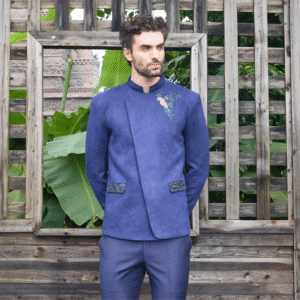 Midnight blue velvet Jodhpuri with Bird of Paradise motif on one shoulder and sleeve. Paired with matching trouser.