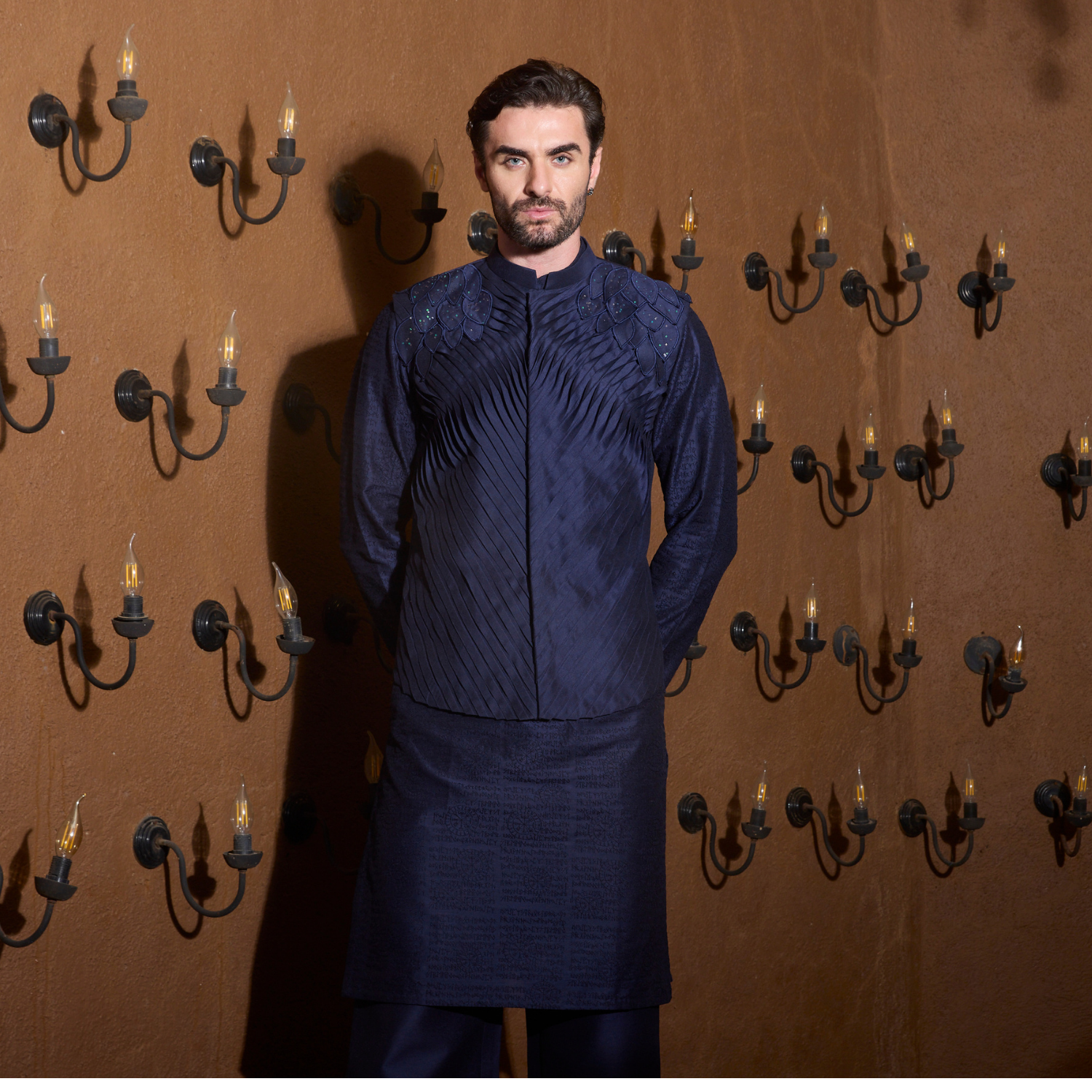 Midnight blue hand pleated Jacket with fabric leaves detailing on the shoulder. Paired with matching flared trouser.