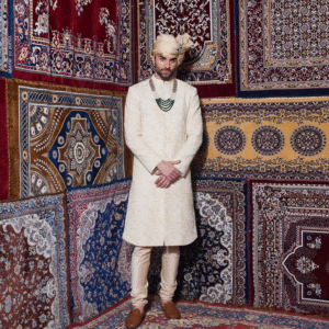 Hand embroidered pistachio Sherwani with pearl detailing all over. Paired with matching churidar. Accessorised with safa.
