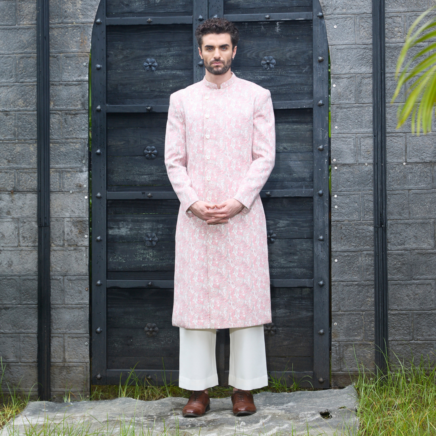 Old rose paisley printed long Bandhgala with off white trouser.