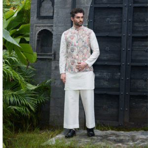 Hand embroidered off white Jacket with sequins & thread detailing all over. Teamed up with monotone look kurta & churidar.