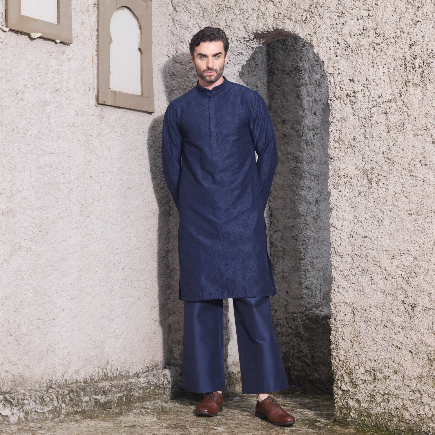 Midnight blue kurta with Birds of Paradise motif embroidered with sequins & thread on one shoulder and sleeves. Paired with midnight blue trouser.