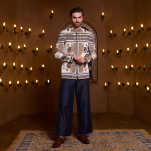 Off white Vintage printed Jodhpuri paired with midnight blue flaired trouser.