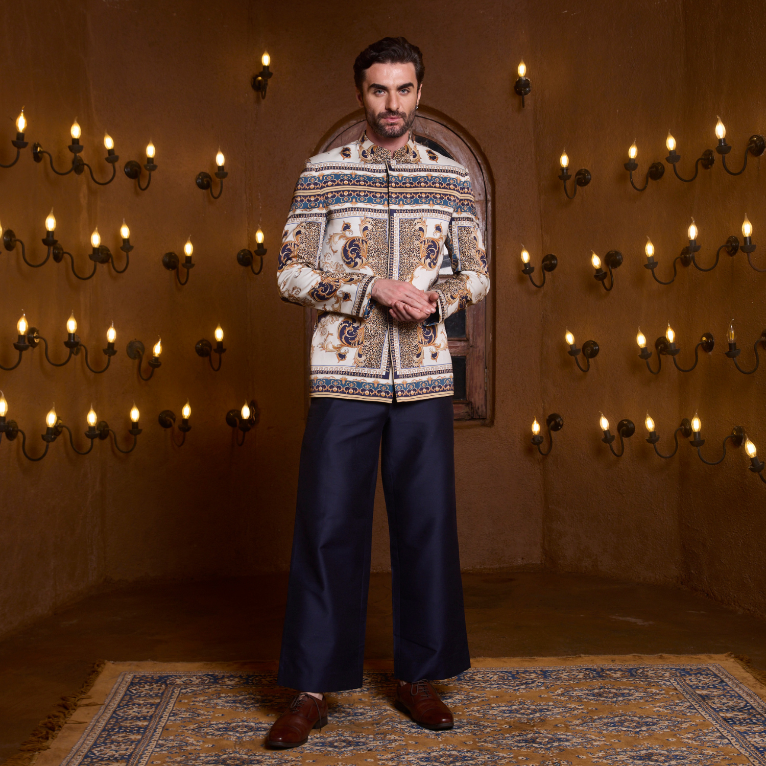 Off white Vintage printed Jodhpuri paired with midnight blue flaired trouser.