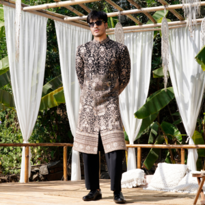 Ebony bandhgala with with intricated hand embroidery all over and rich border detailing in antique gold. Paired with flared matching trouser.