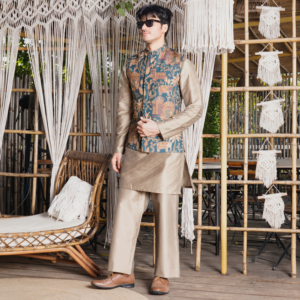 Printed peacock teal jacket paired with copper hand pintucked kurta. Matching flared trouser for bottom.