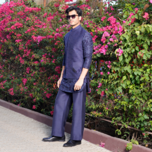 Midnight blue drizzle effect intersecting line jacket. Paired with coordinated midnight blue Milange embroidered short kurta. Matching flared trouser for bottom.