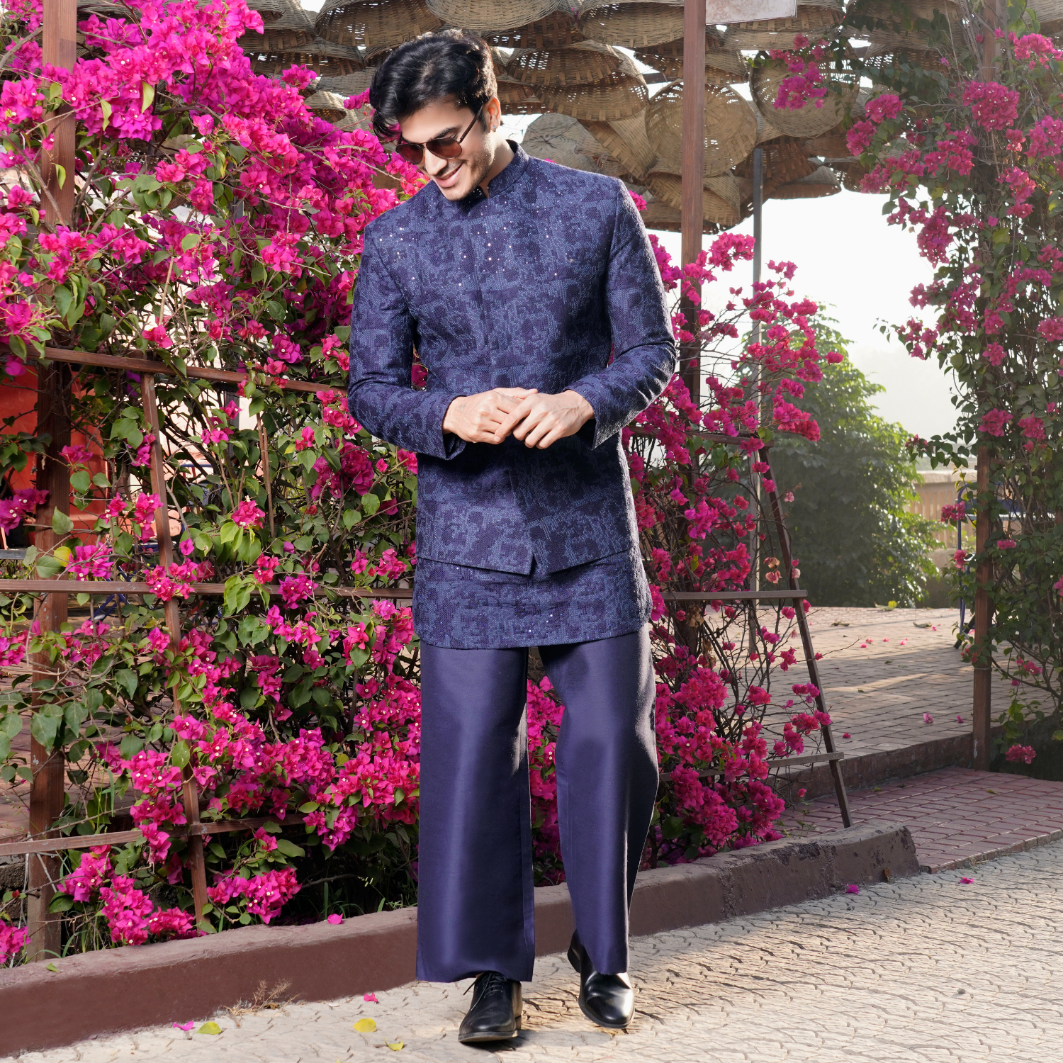 Midnight blue Milange embroidered Jodhpuri jacket with sequins detailing. Paired with matching embroidered short kurta. Matching flared trouser for bottom.