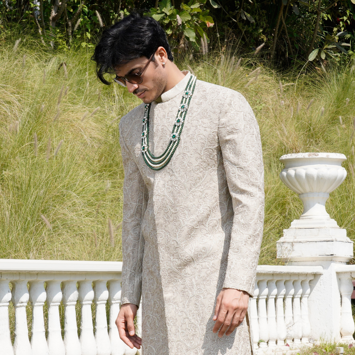 Ivory Bandhgala with hand embroidered detailing all over. Paired with coordinated flared ivory trouser. Accessorised with emerald mala. - Image 2