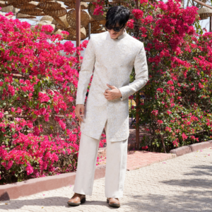 Off white short bandhgala with hand embroidery and sequins detailing. Paired with coordinated flared trouser.